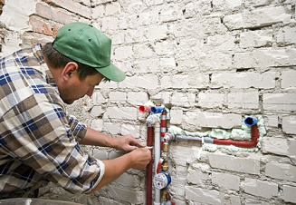 technician handles plumbing in Centennial CO by servicing intake lines